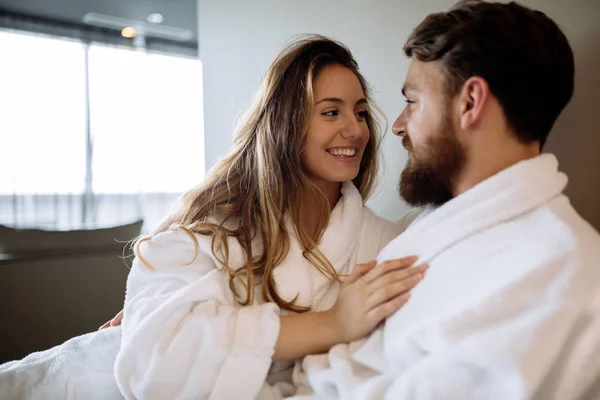 Couple wearing bathrobes in hotel