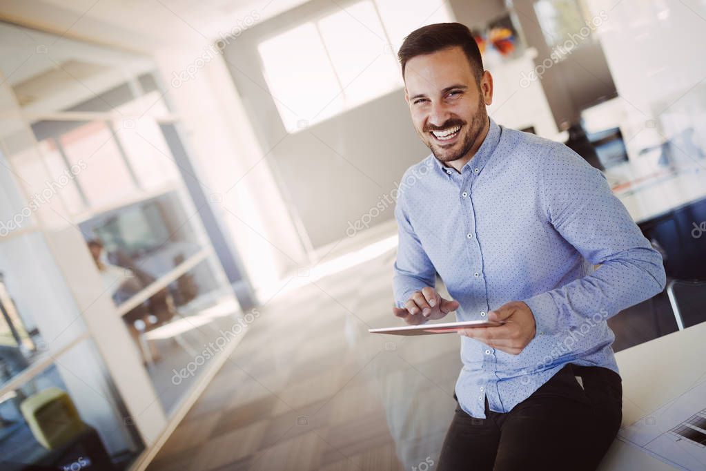 successful architect holding tablet