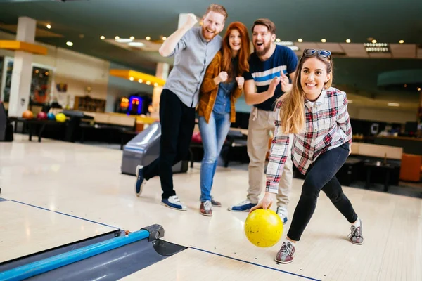 Friends enjoying bowling at club