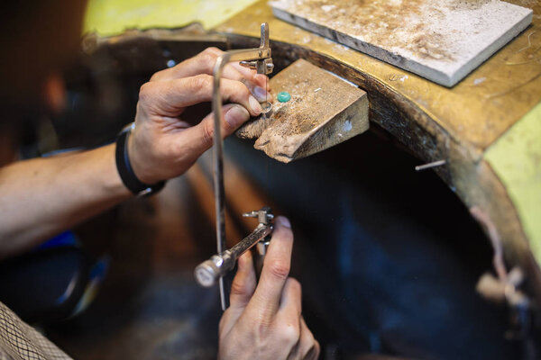 Young goldsmith crafting jewelry
