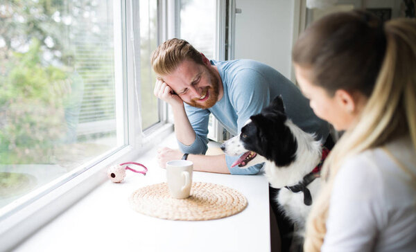 Beautiful couple and loving their dog — Stock Photo, Image