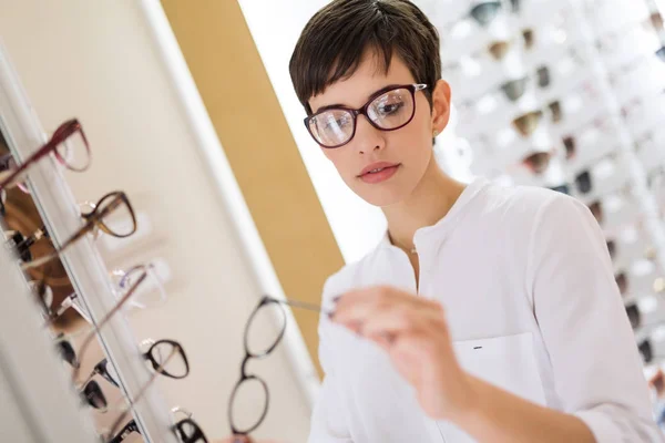 Vrouw is het kiezen van nieuwe bril — Stockfoto