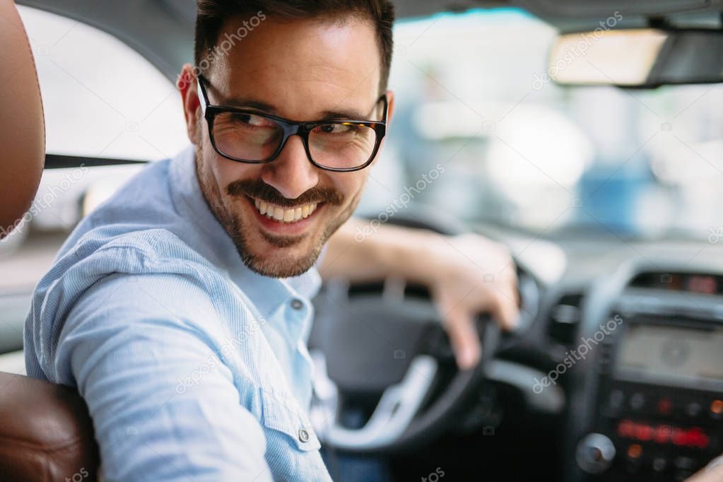 Handsome businessman driving a car