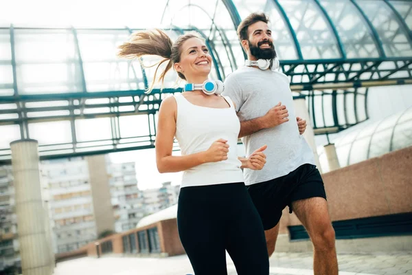 Young fitness couple running — Stock Photo, Image