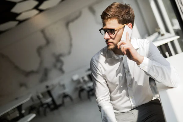 Handsome businessman using phone — Stock Photo, Image