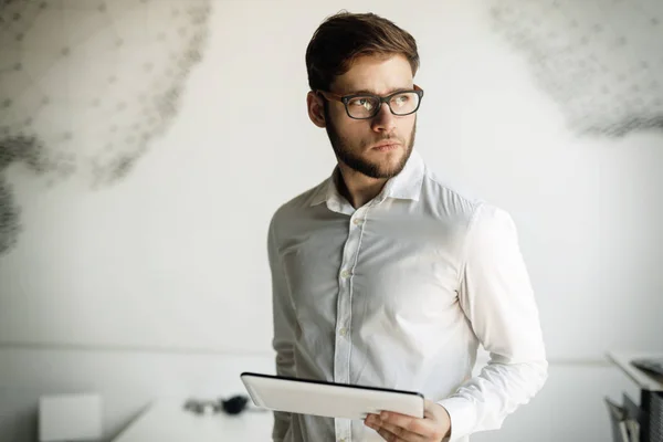 Businessman wearing glasses using tablet — Stock Photo, Image