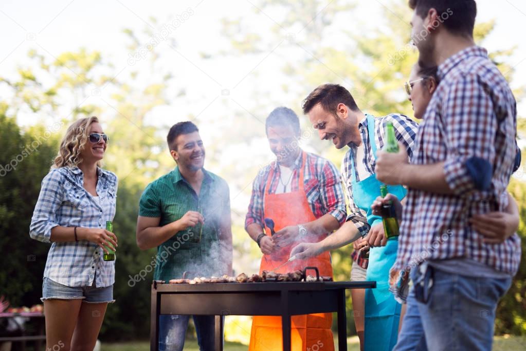 Young people enjoying barbecuing 