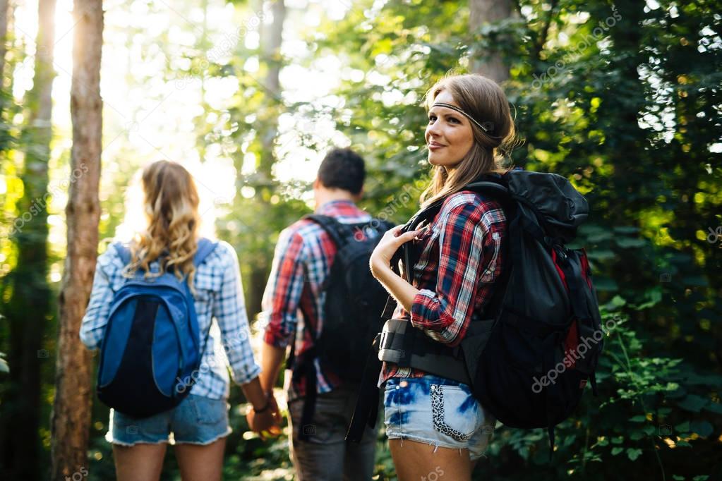 Beautiful woman and friends hiking