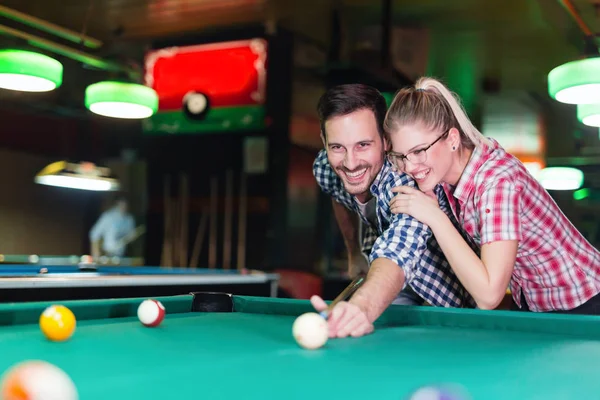 Young couple playing together pool Stock Image