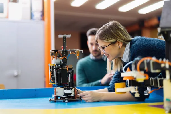 Junge Ingenieurin testet ihren Roboter — Stockfoto