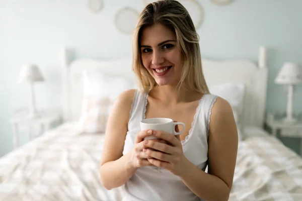 Young beautiful woman  drinking coffee