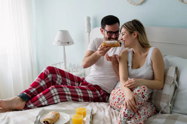Ζευγάρι τρώει πρωινό στο κρεβάτι — Φωτογραφία Αρχείου