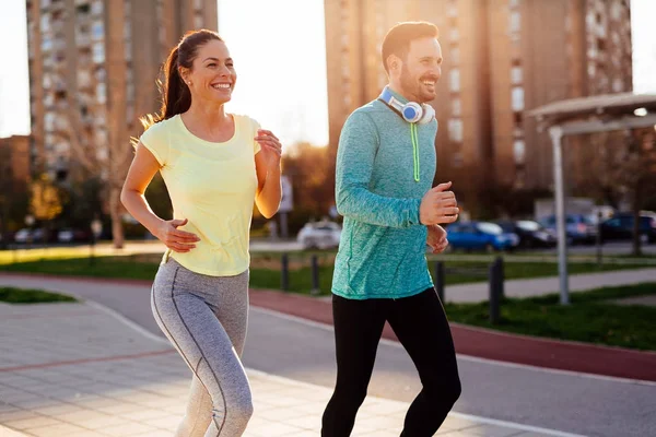 Young attractive couple running — Stock Photo, Image