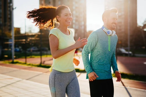 Young attractive couple running — Stock Photo, Image