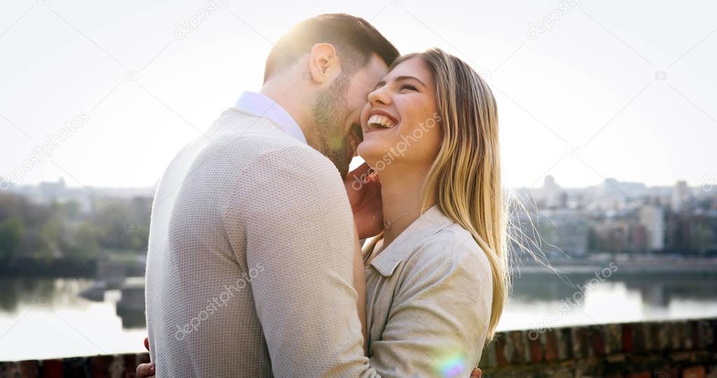 Couple kissing dating on bridge