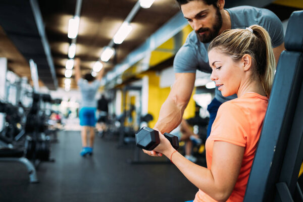 woman doing exercises with personal trainer