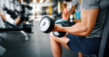 Kaslı vücut geliştirmeci adam egzersizleri yapıyor