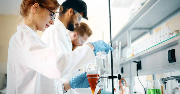 Young students of chemistry working in laboratory — Stock Photo, Image