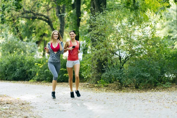 Athletic women jogging in nature — Stock Photo, Image