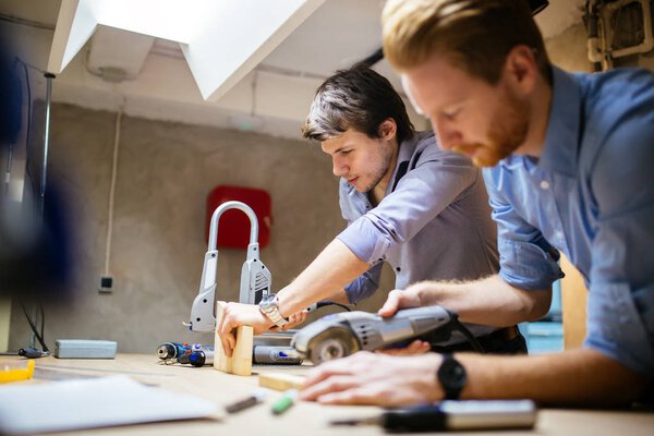 Two creative designers working in workshop