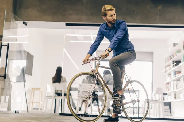 Smart businessman riding a bicycle to work