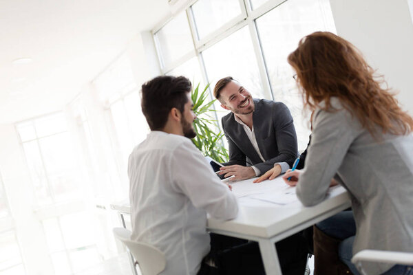 Team of architects working together on project in office