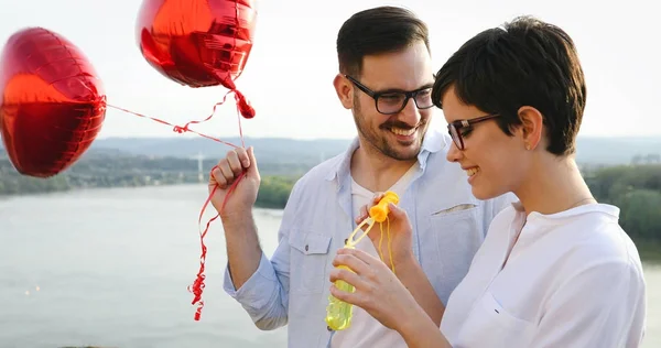 Sorrindo casal apaixonado por balões — Fotografia de Stock