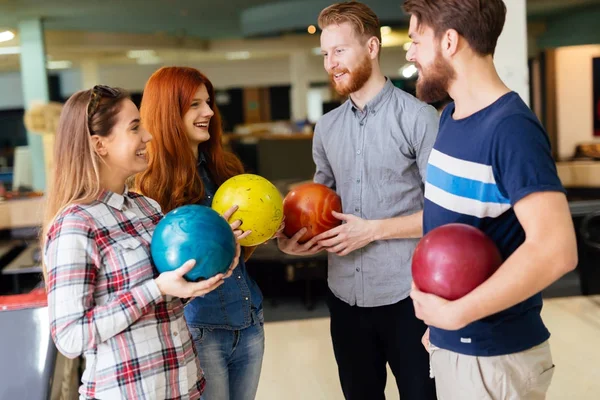 Friends enjoying bowling at club