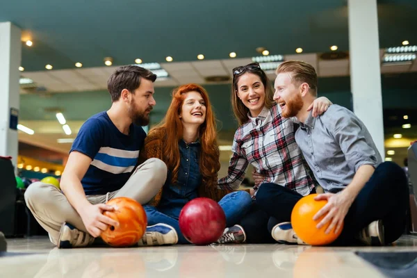 Friends enjoying bowling at club