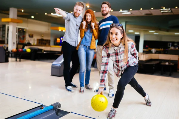 Friends enjoying bowling at club