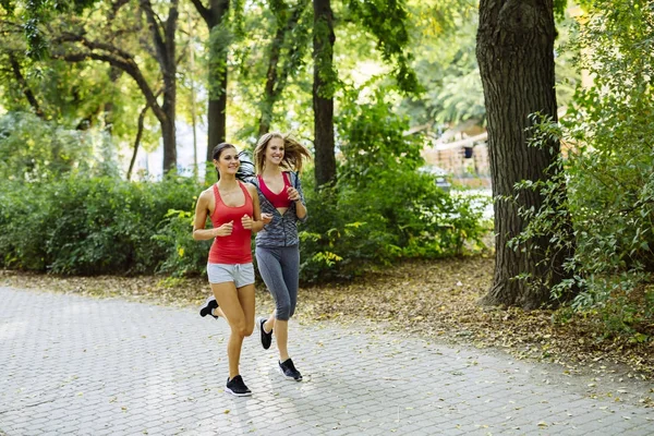 Young fit women jogging outdoors — Stock Photo, Image