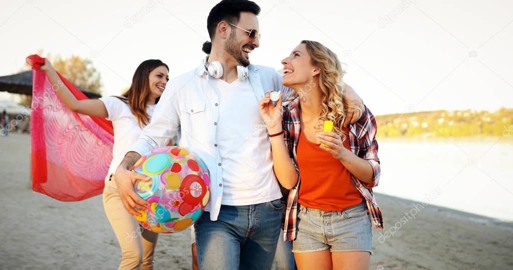 Group of young cheerful people bonding to each other and smiling