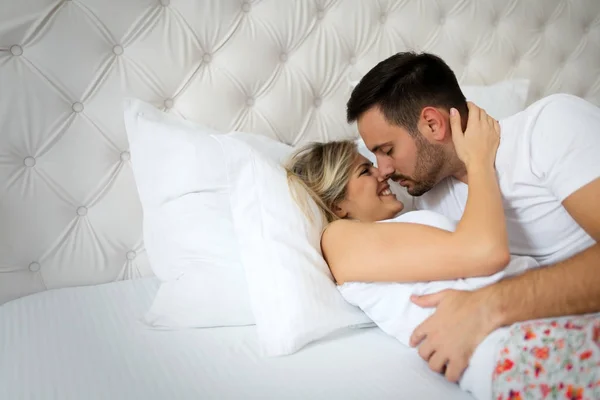 Άνθρωπος και όμορφη γυναίκα, φιλί στο κρεβάτι — Φωτογραφία Αρχείου