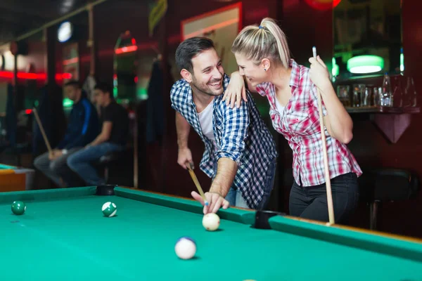 Jovem casal jogando juntos piscina no bar — Fotografia de Stock