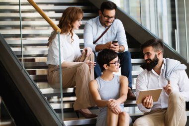 İş arkadaşları yeni fikirleri tartışıyor ve modern bir ofiste beyin fırtınası yapıyorlar.