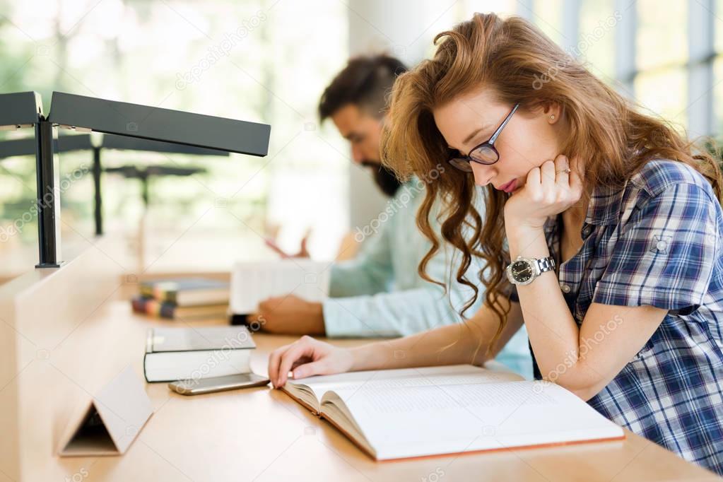 Young students studying in library