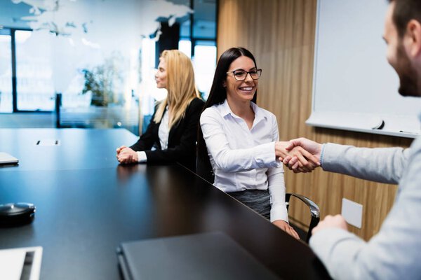 Portrait of attractive business couple in conference room