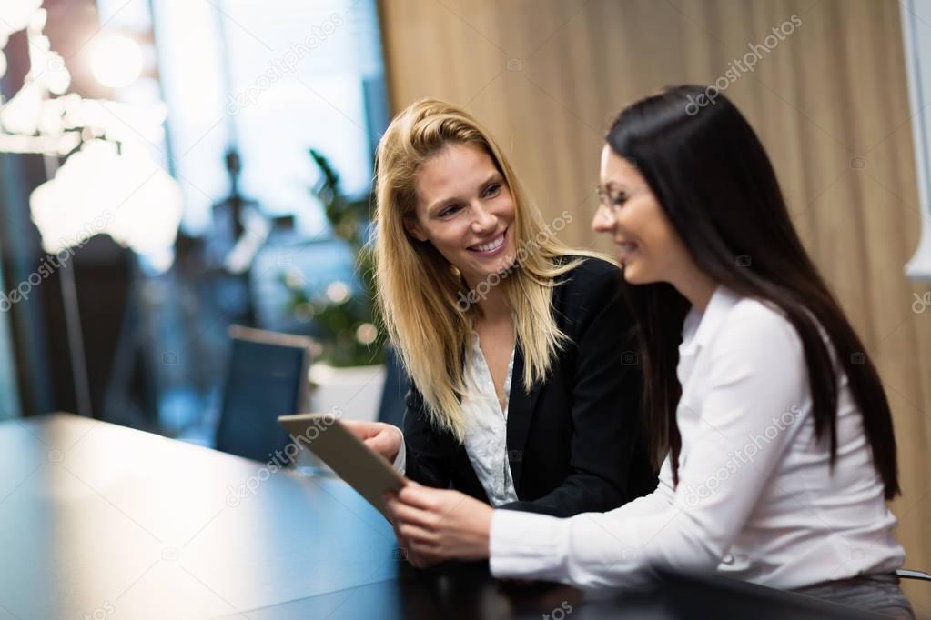 Two attractive businesswomen having discussion in conference room