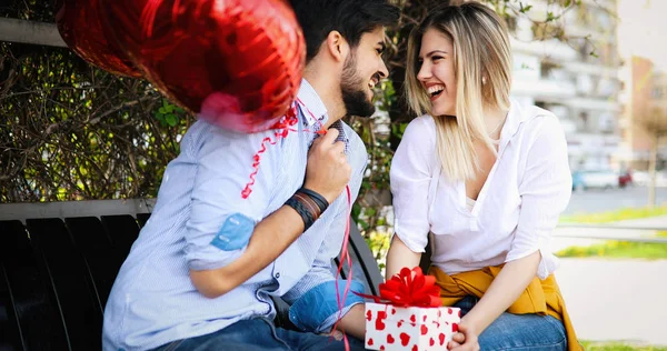 Picture of romantic couple standing outside with baloons — Stock Photo, Image