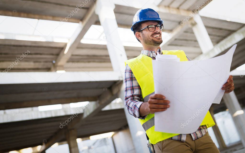 Picture of construction site engineer looking at construction plan