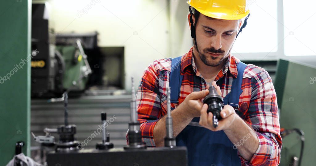 Male worker and quality control inspection in metal industry factory