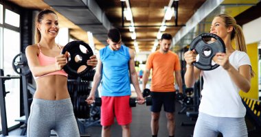 Group of friends exercising together in gym  clipart
