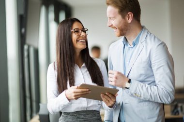 İş adamları ofiste dijital tablet kullanırken tartışıyor