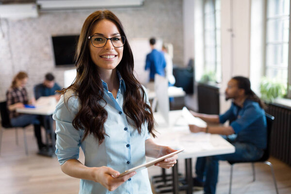 Portrait of young beautiful smiling architect in office