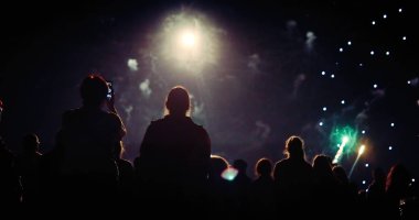 Kalabalık havai fişekleri izliyor ve geceleri kutlama yapıyor.