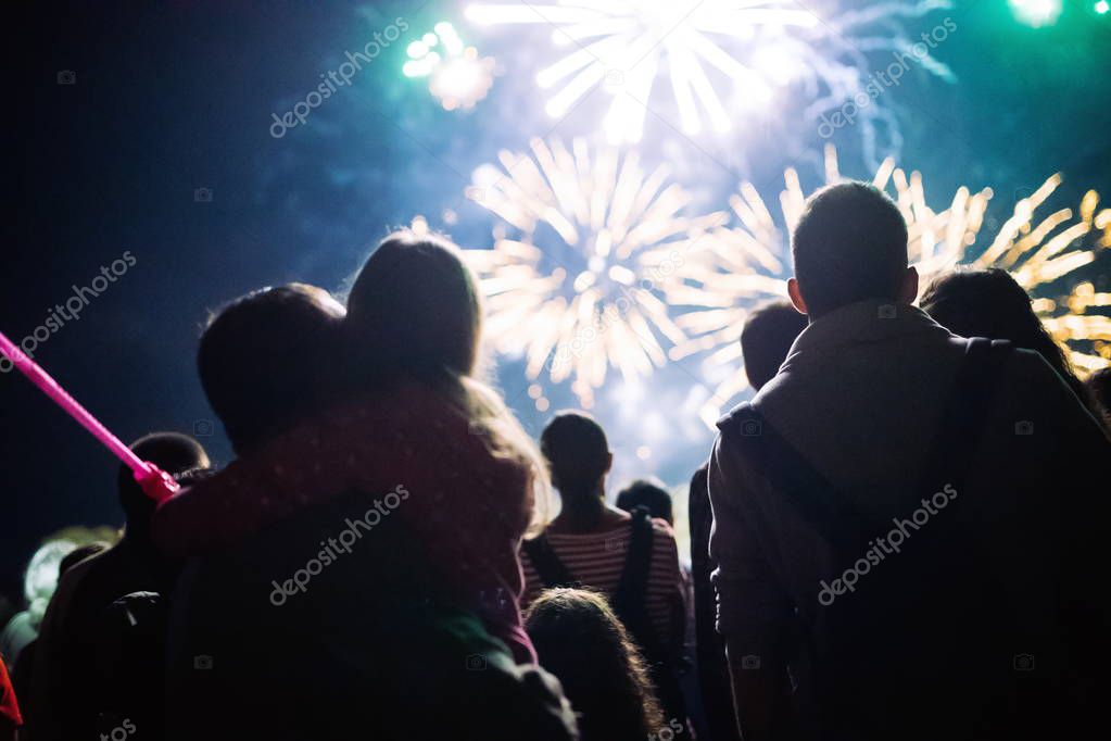Crowd watching fireworks and celebrating at night