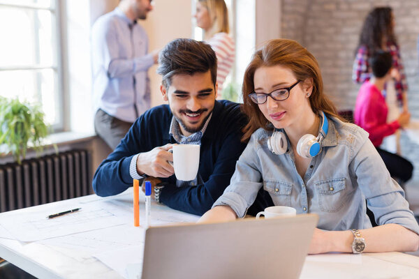 Коллеги по работе беседуют на рабочем месте и делятся идеями
