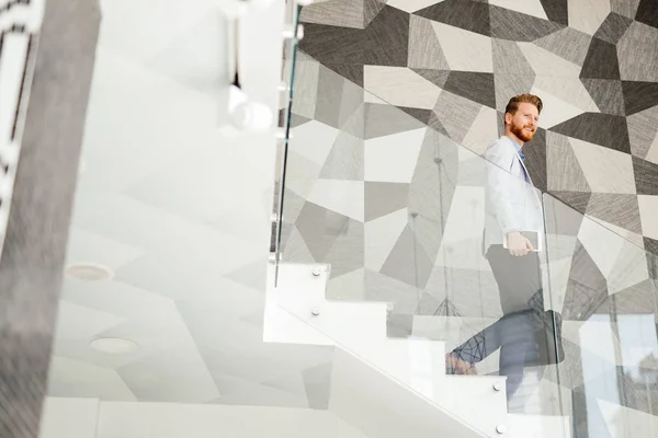 Businessman in suite portrait on stairs in office building