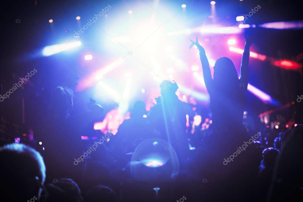 Portrait of happy crowd enjoying and dancing at music festival