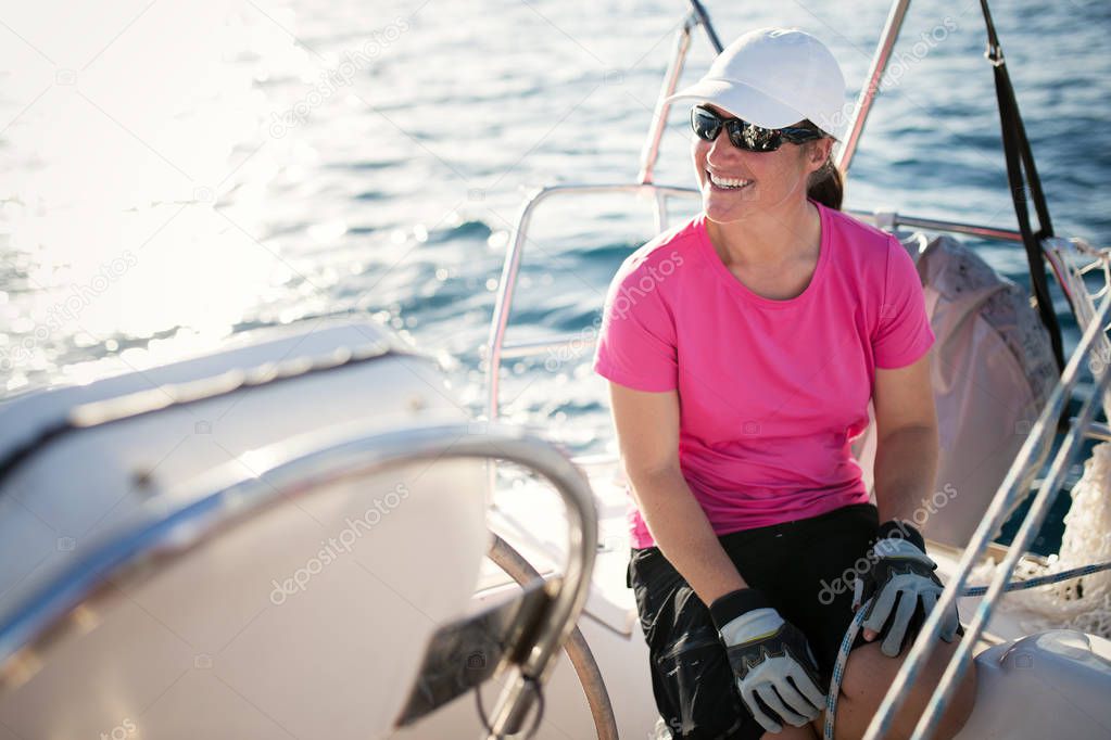Happy strong sport woman sailing with her boat
